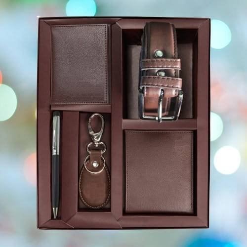 Luxury hamper items list Nigeria: Ankara laptop bag, engraved flask, notebook and artisanal treats arranged in a cane box