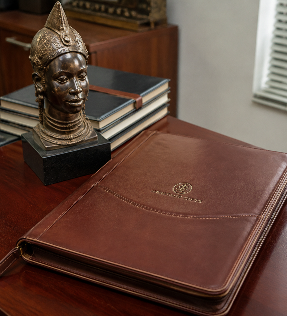 Unique corporate giveaways in Nigeria for executives: embossed leather document folder and bronze sculpture