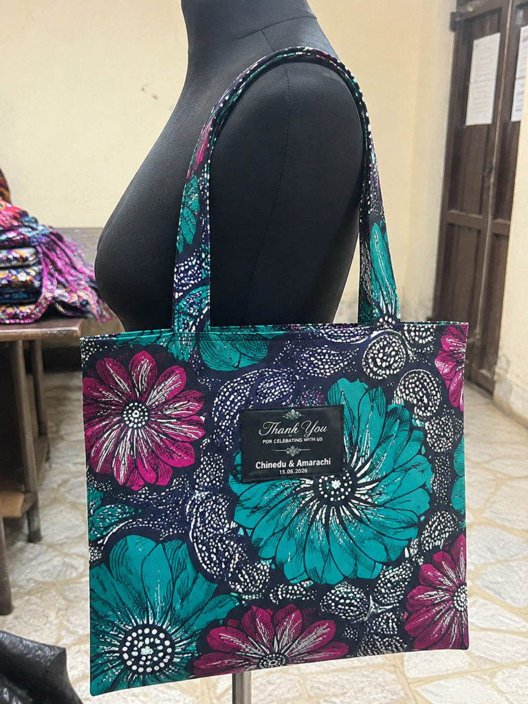 Bulk wedding souvenir ideas in Nigeria: Ankara print tote bags and custom backpacks ready for an Owambe event